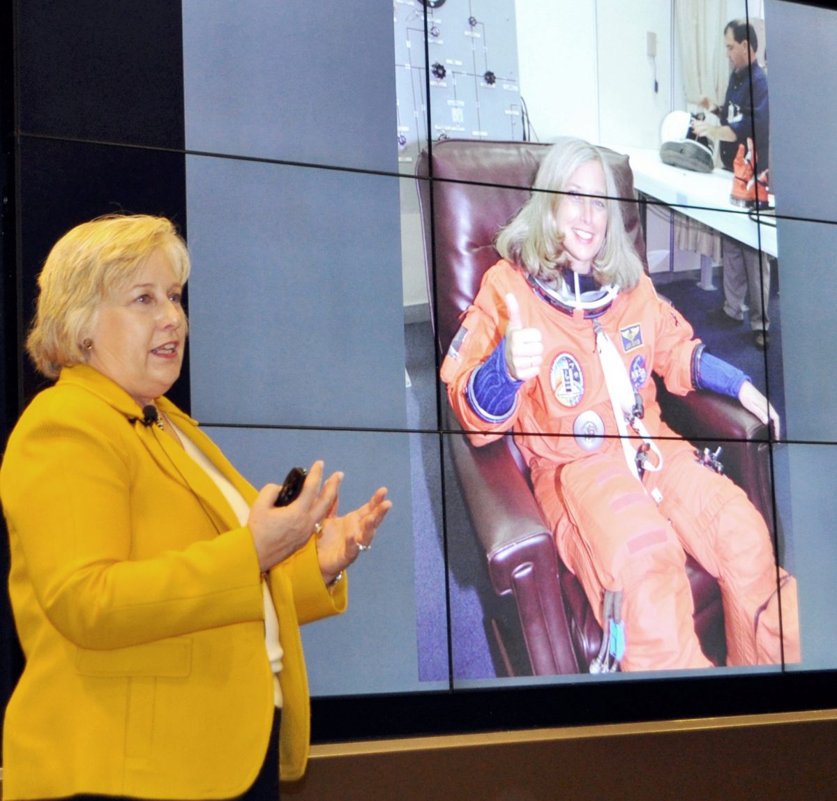 Jan Davis stands before an image of herself as a NASA astronaut