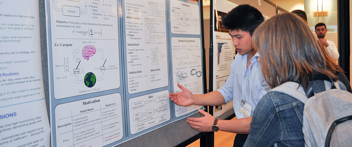 Gabriel Nakajima An shows another student his research poster