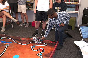 IMEET student watches as his rover completes the mission