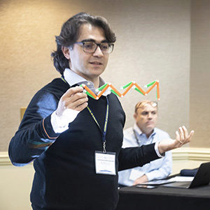 Attendee at metastructures conference showing a structure to the audience