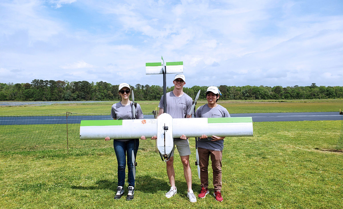 Alex Miner, Andy Person, and Gen holding their award winning drone, S.T.O.R.M.