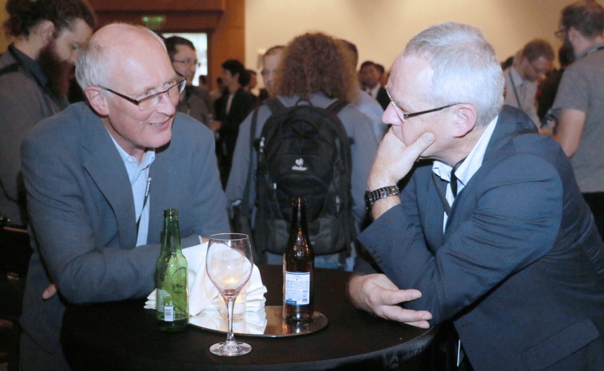 Two attendees of the IEPC discuss ideas at the opening reception