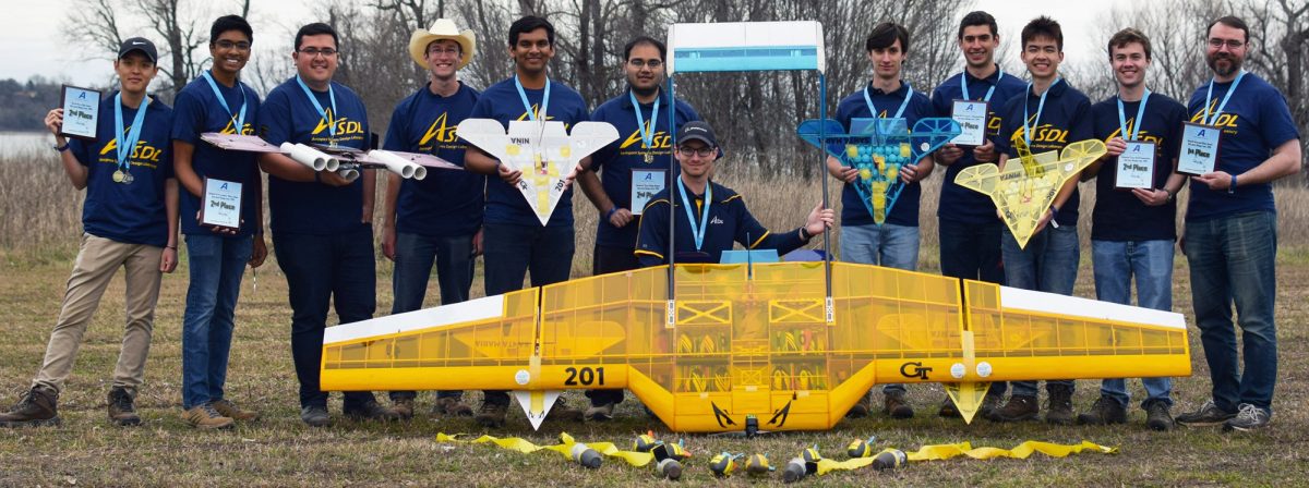 The Georgia Tech Design Build Fly Team poses with their 1st place and 2nd place planes