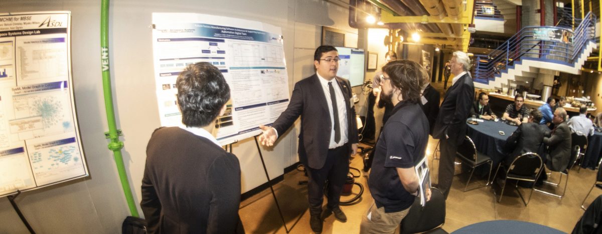 AE Student presenting his poster to visitors at the Boeing review session