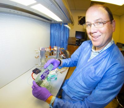 Glenn Lightsey holding a ceramic thruster