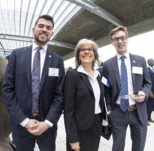 Two students with Lockheed Martin executive Beverly Baughman