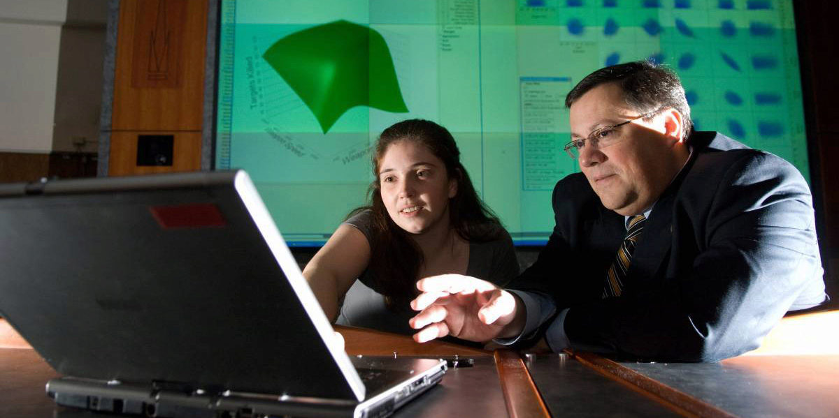 Prof. Dimitri Mavris and student looking at computer
