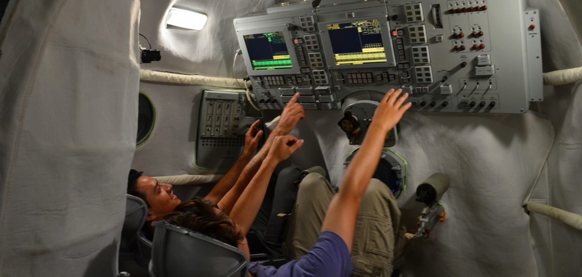 Nelson Guecha and another student in a Soviet-era space capsule in a museum in Russia