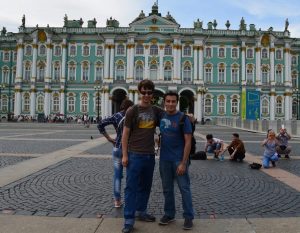 Nelson Guecha and a friend in front of an ornate building in Russia