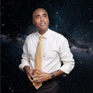 Prof. Stephen Ruffin looking up at the stars with a photo of the galaxy behind him