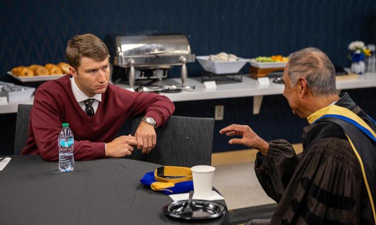 Dr. Sankar talking to student at grad ceremony