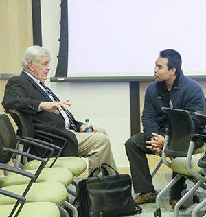 Daniel Schrage talking with a student