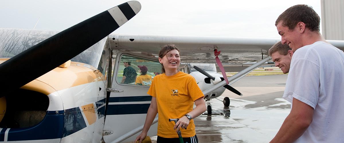 students looking at plane