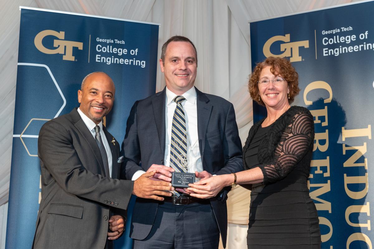 Ben Bellows (center) accepts CoE award alongside Dean Beyah (left) and Sandy Magnus (right).