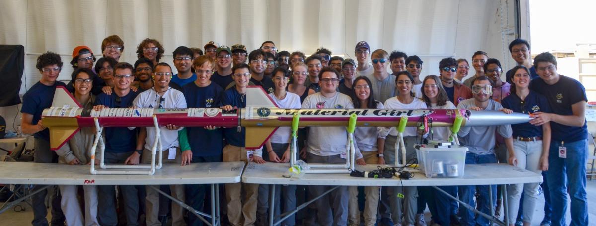 The Ramblin' Rocket Club poses proudly with their new sounding rocket named Material Girl. 